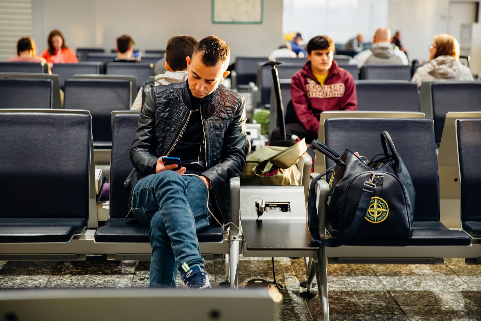 Traveller checking gate information on a phone using the mobile site